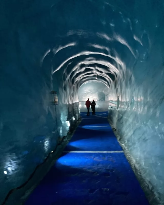 ❄️ Walking Inside a Glacier at Mer de Glace! 🏔️  Swipe through to see one of the most incredible (and sobering) experiences we’ve ever had in Chamonix. A visit to this massive glacier is absolutely breathtaking—but each year, it’s disappearing more and more.  📍 To get there, we took a scenic cogwheel train and then a gondola. When the ice cave was first carved out, it was right at the base of the gondola. When we visited you had to walk 530 steps down to reach it… and they have been adding more every year as the ice melts. This past December, they unveiled a new gondola to help get visitors closer, but there are still nearly 200 steps down.  Standing inside the glacier was an unforgettable experience, but also a stark reminder of how fast our world is changing. So glad we got to see it while it’s still here.  Have you ever walked inside a glacier? Would you visit? Let me know below! 👇  #Chamonix #MerDeGlace #ClimateChange #TravelMoments